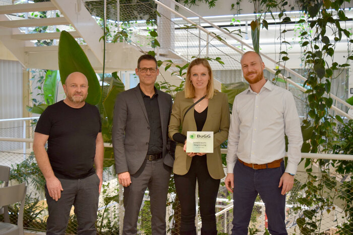 Überreichung der Siegerplakette in Mitten der Innenraumbegrünug in Zürich: Gerhard Zemp (Aplantis), Dr. Gunter Mann (BuGG), Livia Küchler (Luwasa Greenstyling) und Stefan Koller (Implenia) (v.l.n.r.)